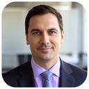 Portrait of a CTO in a modern office with soft daylight and a neutral background
